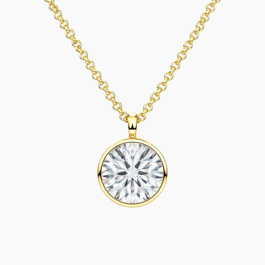Gold chain necklace with round brilliant moissanite solitaire pendant on white background