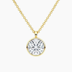 Gold chain necklace with round brilliant moissanite solitaire pendant on white background