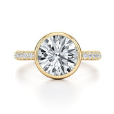 Yellow gold moissanite engagement ring with round brilliant center stone and pavé band