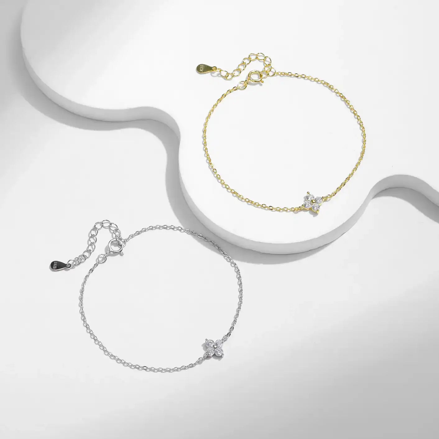 Gold and silver moissanite star bracelets with minimalist chain on white background