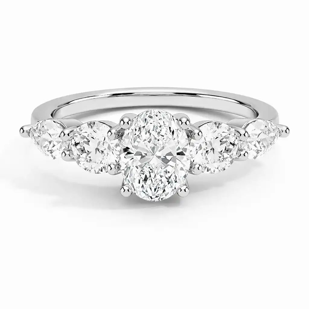 Oval moissanite engagement ring with round side stones in a silver band, brilliant cut.