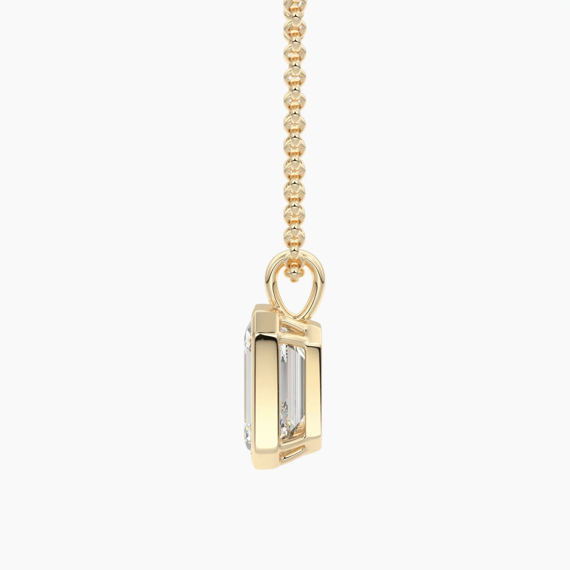 Gold chain necklace with a rectangular moissanite pendant, side profile view