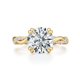 Round moissanite solitaire engagement ring with twisted gold band and pavé accents