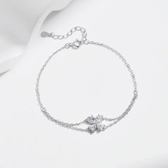 Delicate moissanite flower bracelet with silver chain on white background