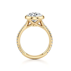 Yellow gold moissanite engagement ring with side stones and a round brilliant center stone