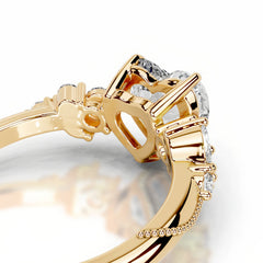 Close-up of gold moissanite ring with heart-shaped setting and sparkling stones