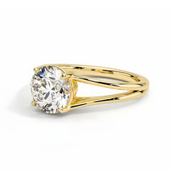 Round moissanite solitaire ring with split shank yellow gold band on white background