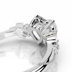 Close-up of silver moissanite ring with prong-set gemstones and intricate detailing