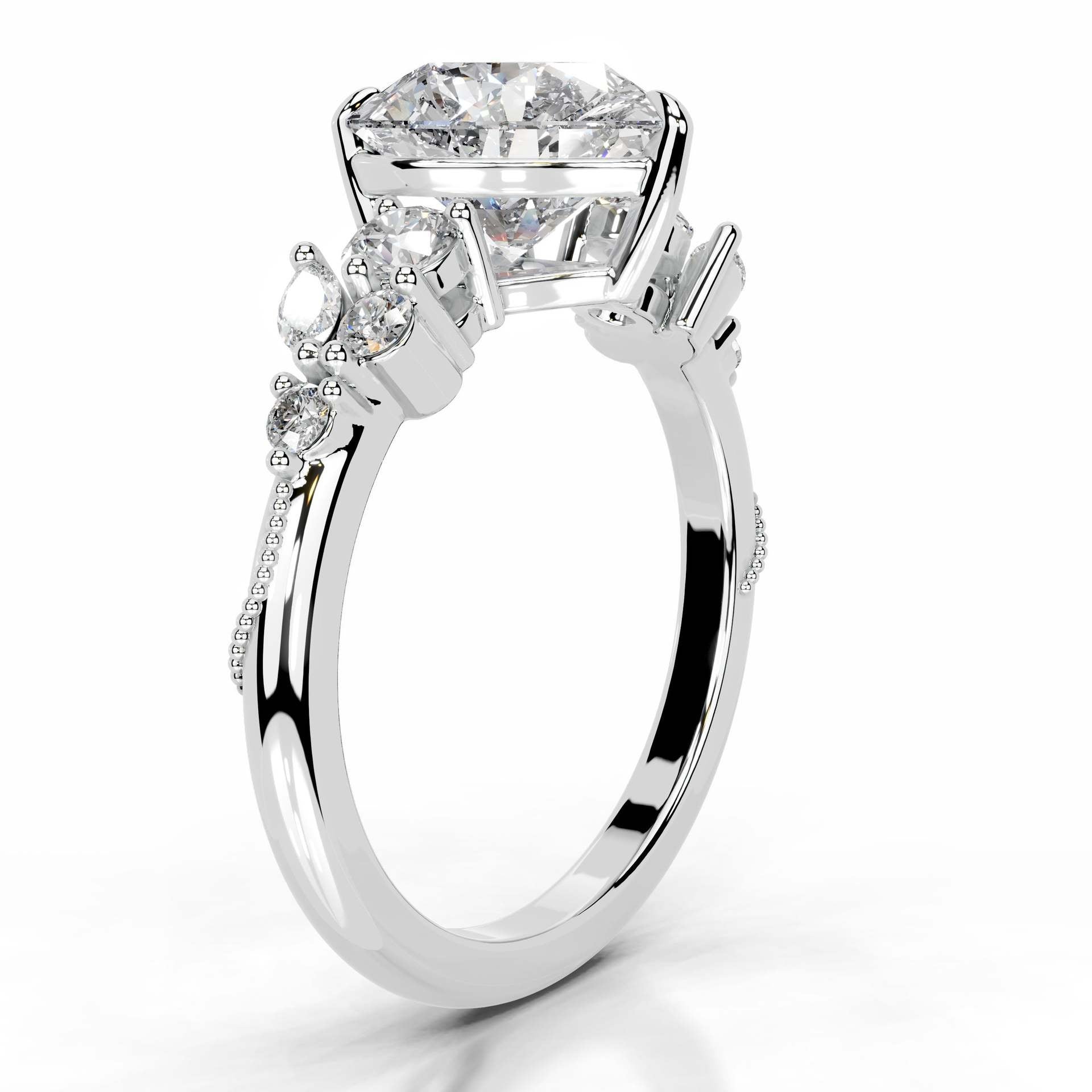 White gold ring with a large moissanite center stone and side accent stones on a polished band