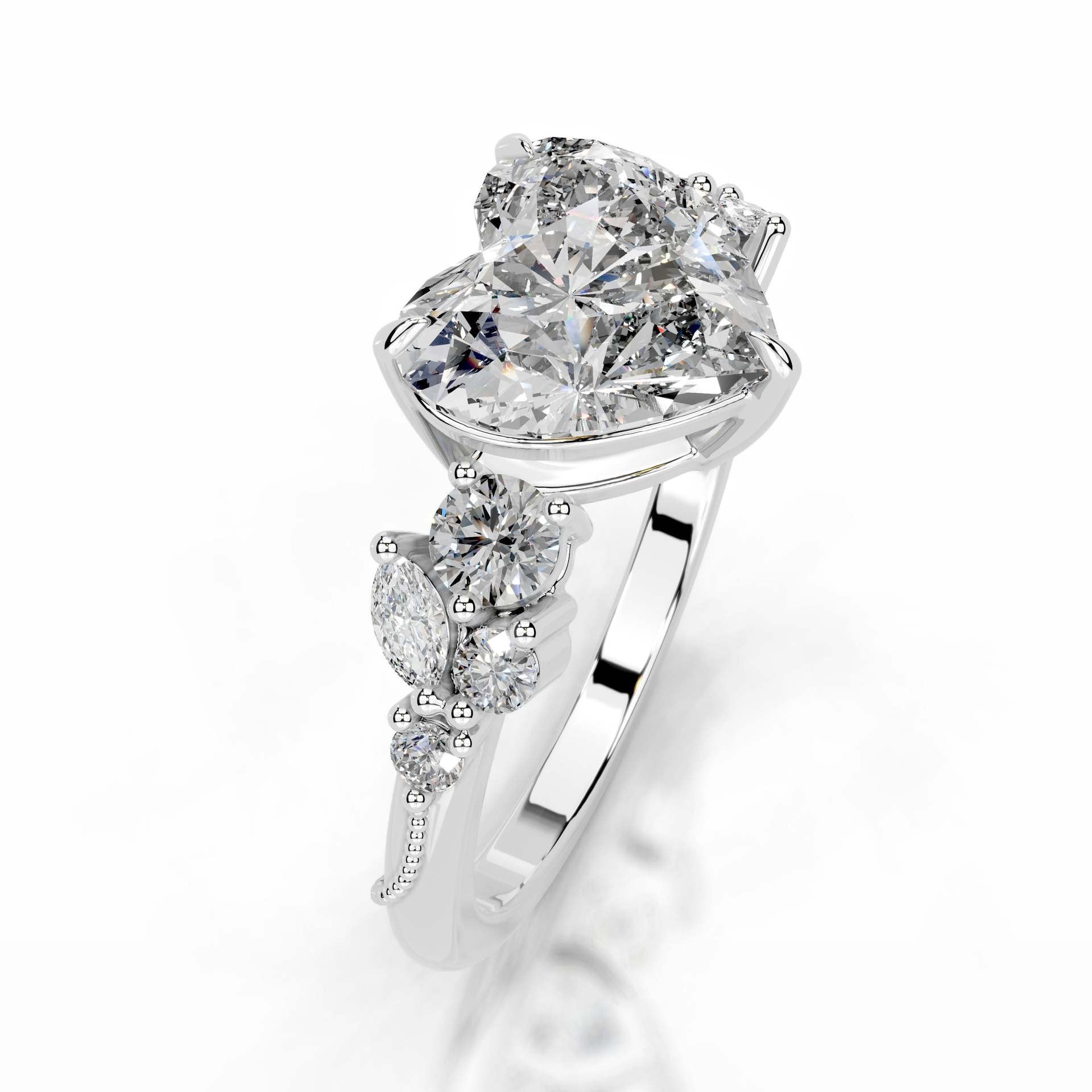 Heart-shaped moissanite engagement ring with diamond-like side stones on silver band