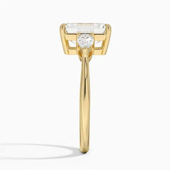 Yellow gold ring with emerald-cut moissanite center stone, side profile view