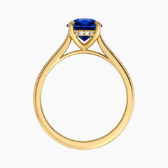 Front view of an 18K gold-plated ring highlighting the basket setting, hidden halo, and a vibrant 2-carat oval lab-grown blue sapphire