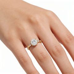 Hand wearing a gold moissanite engagement ring with brilliant round center stone