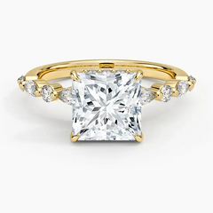Princess cut moissanite engagement ring with gold band and side stones