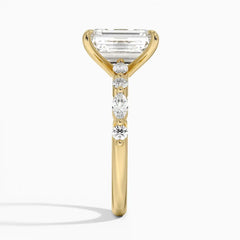 Side view of a gold ring with a large emerald-cut moissanite and accent stones