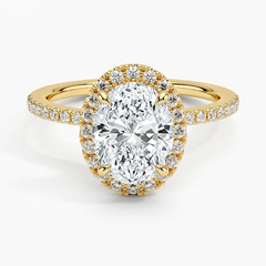 Oval cut moissanite halo engagement ring with gold band and pavé side stones