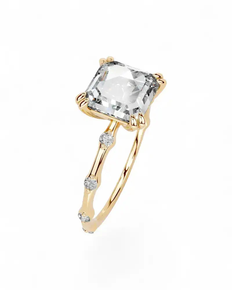 Gold ring with large square moissanite center stone and small accent gems on band