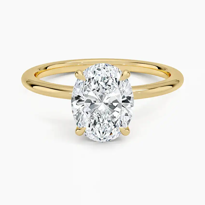 Oval cut moissanite solitaire engagement ring with yellow gold band