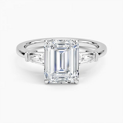 Emerald cut moissanite engagement ring with tapered baguette side stones in white gold