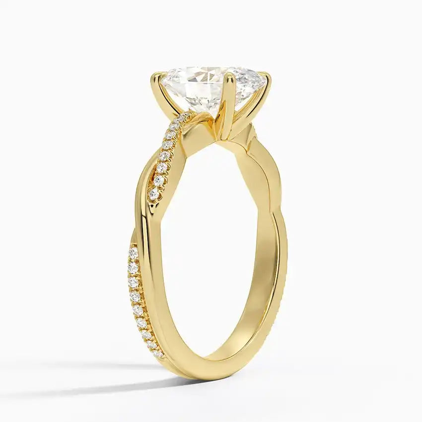 Gold moissanite engagement ring with pavé side stones and twisted band design