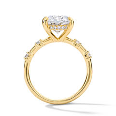 Gold moissanite engagement ring with round brilliant center stone and pavé side details