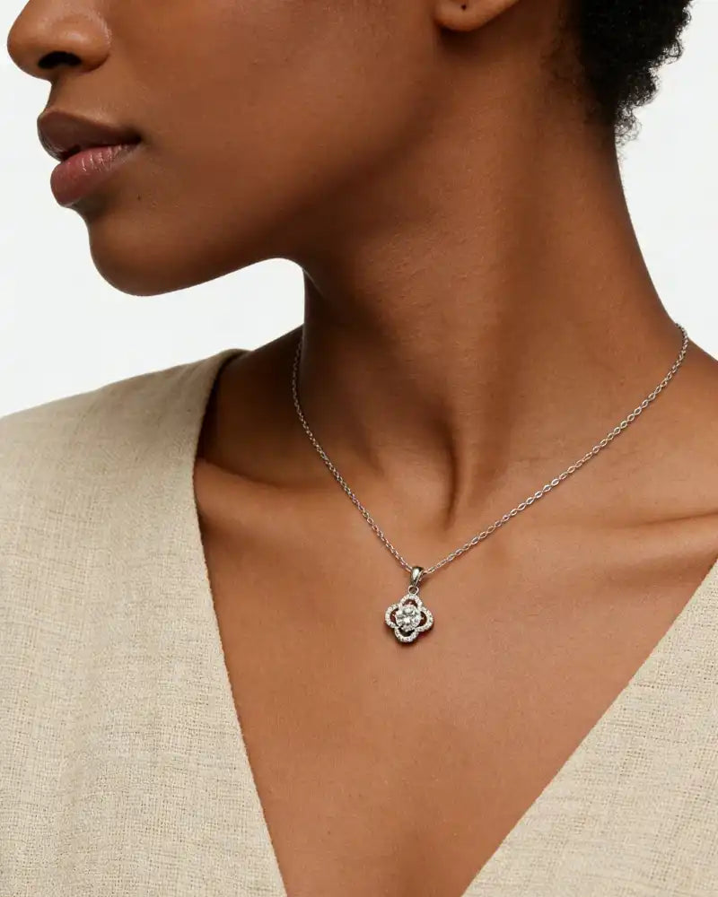 Woman wearing a moissanite flower pendant necklace on a silver chain