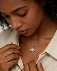 Woman wearing a moissanite flower pendant necklace on a silver chain