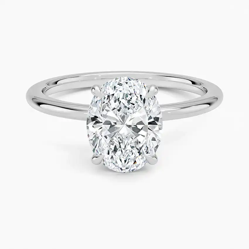 Oval cut moissanite solitaire engagement ring with minimalist silver band