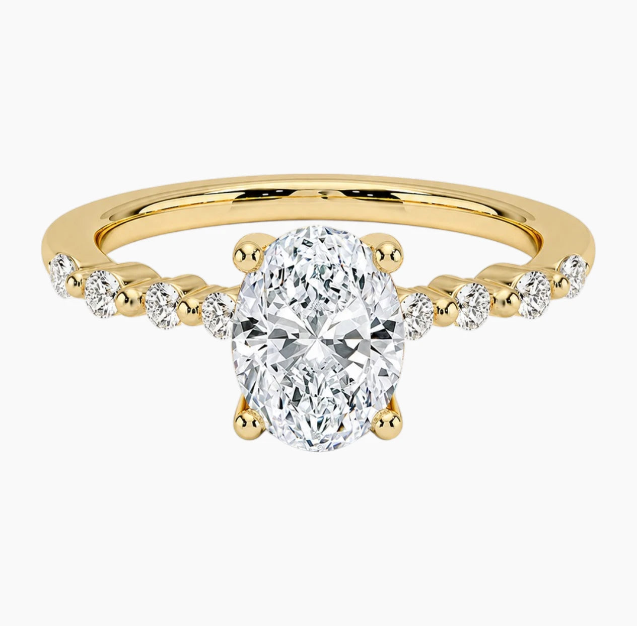 Oval-cut moissanite ring featuring an 18K white gold-plated band set with pavé diamonds; an elegant solitaire-style engagement ring.