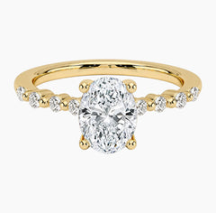 Oval-cut moissanite ring featuring an 18K white gold-plated band set with pavé diamonds; an elegant solitaire-style engagement ring.