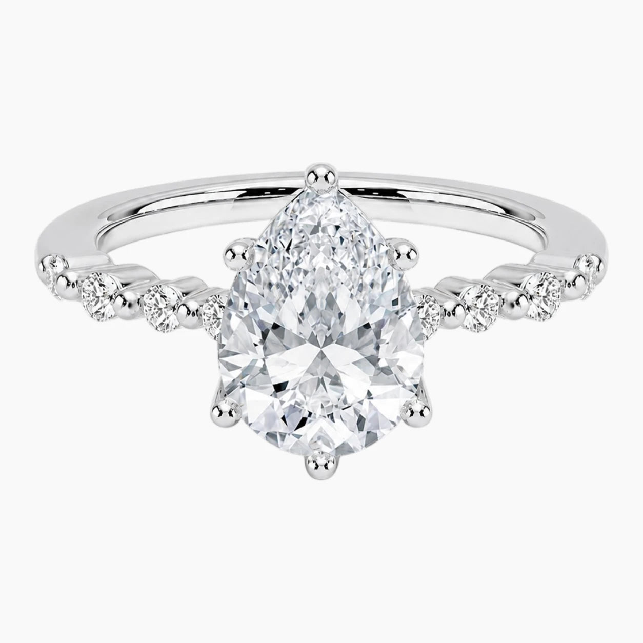 Pear-cut moissanite ring featuring an 18K white gold-plated band set with pavé diamonds; an elegant solitaire-style engagement ring.
