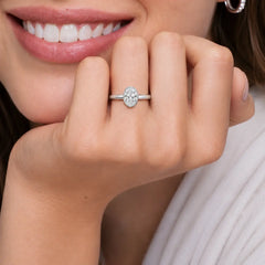 Oval bezel moissanite ring worn on the hand featuring a polished 2.6mm comfort-fit band.