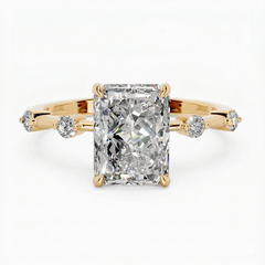 Radiant cut moissanite solitaire ring with gold band and side accent stones
