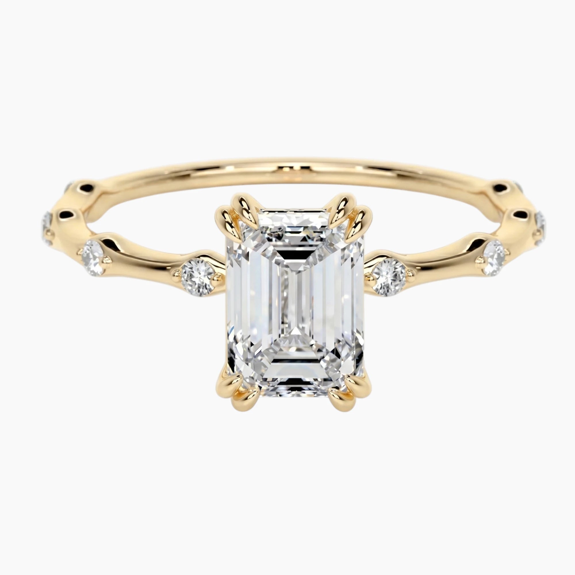 Yellow gold moissanite engagement ring with side accent stones on white background