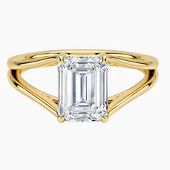 Emerald cut moissanite solitaire ring with split shank yellow gold band