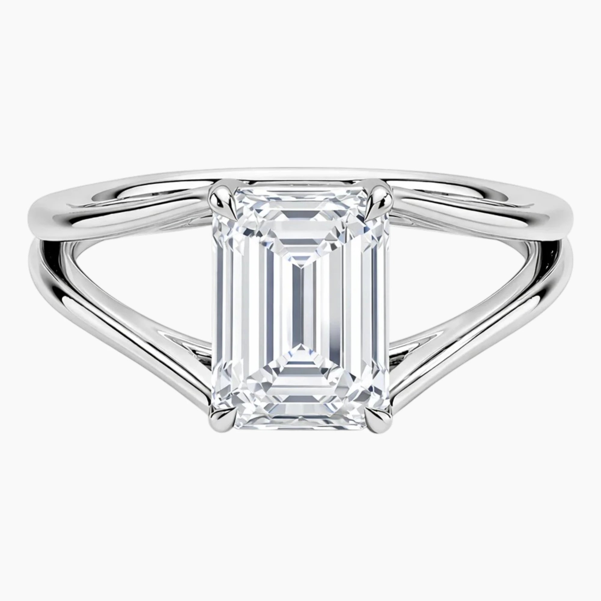 Emerald cut moissanite solitaire engagement ring with split shank in white metal