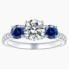 Three stone moissanite and blue sapphire engagement ring in white gold setting