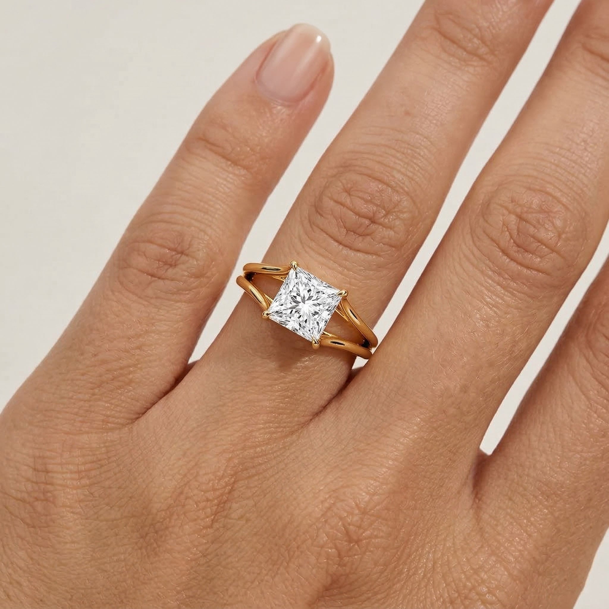 Princess cut moissanite gold ring on hand, ethical sparkling engagement jewelry