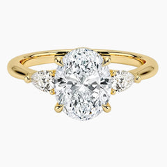 Oval moissanite engagement ring with side stones on yellow gold band