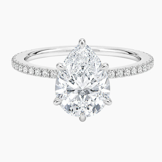 Pear-shaped moissanite engagement ring with pavé band in white gold setting