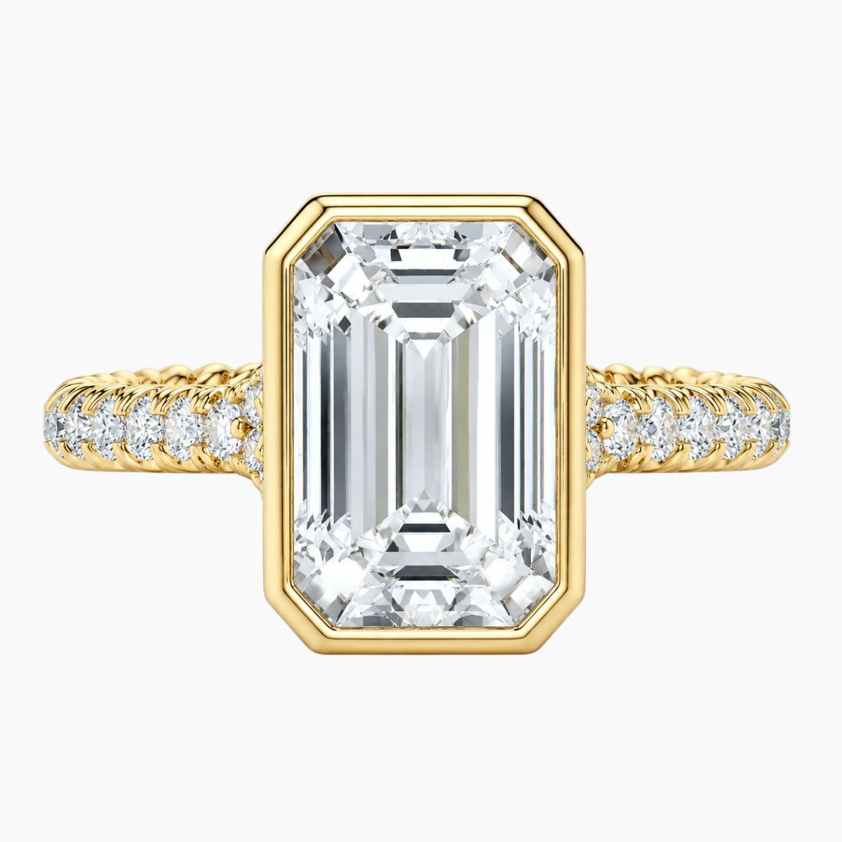 Emerald cut moissanite ring with gold band and pavé setting