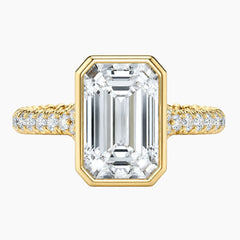 Emerald cut moissanite ring with gold band and pavé setting