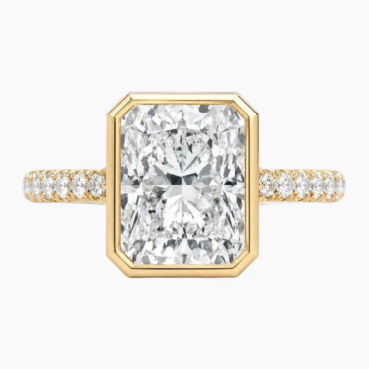 Radiant cut moissanite engagement ring with gold band and pavé side stones