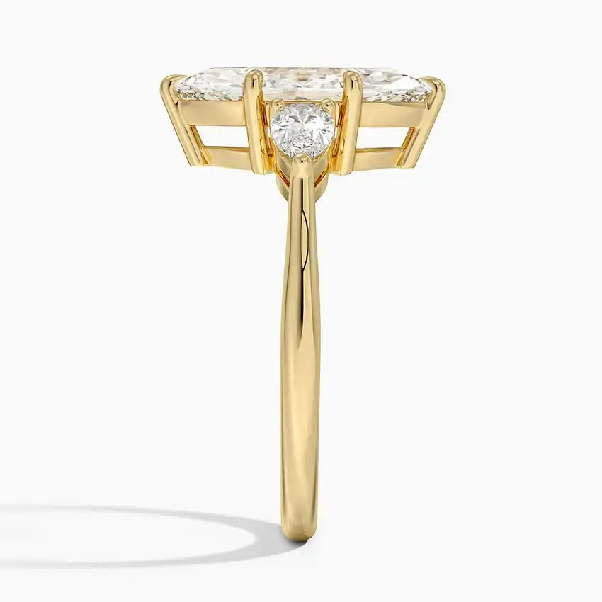 Side view of a gold ring with a large moissanite center stone and two accent stones