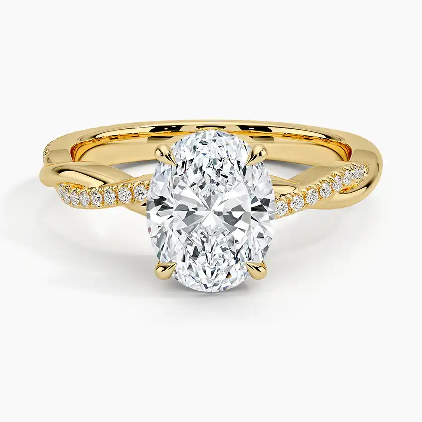 Oval moissanite engagement ring in yellow gold with twisted diamond band