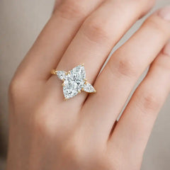 Gold ring with four marquise-cut moissanite stones on a woman's hand
