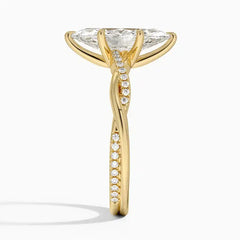 Gold moissanite engagement ring with pavé band and twisted setting, side view