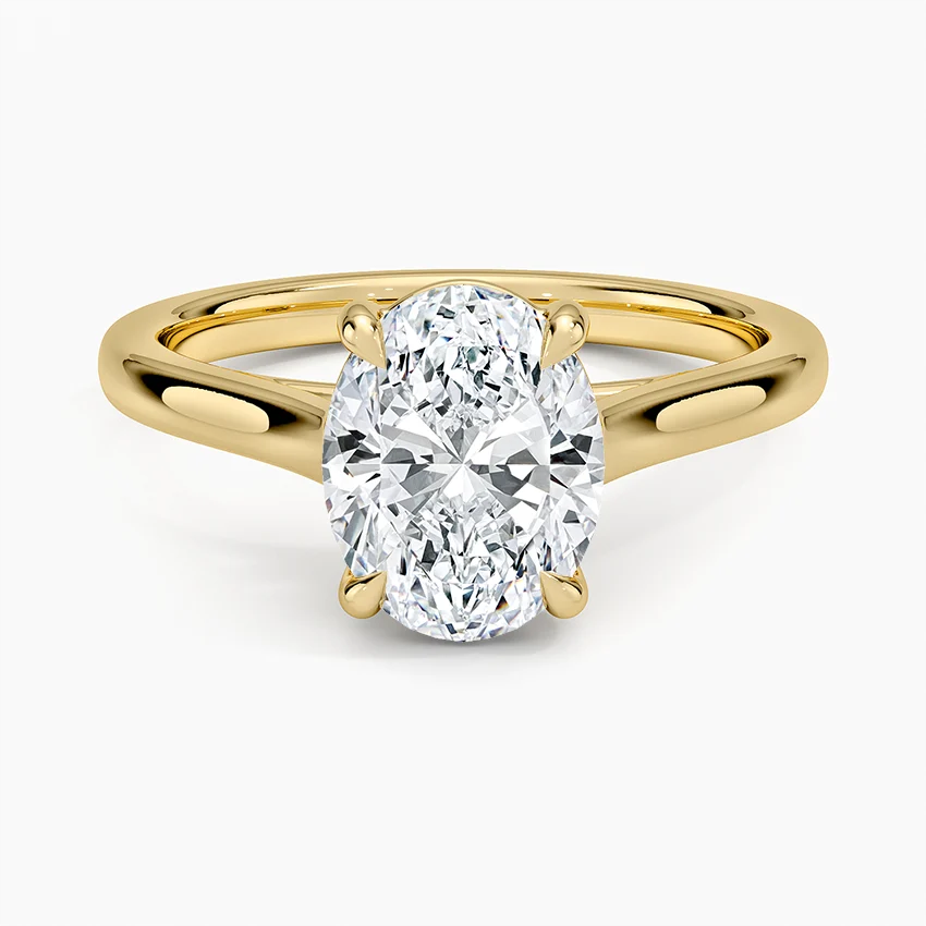 Oval moissanite engagement ring with gold band, solitaire setting, sparkling brilliance