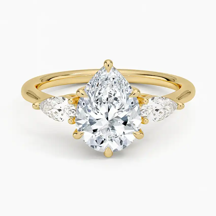 Gold band ring with pear-shaped moissanite center stone and side stones, luxury jewelry