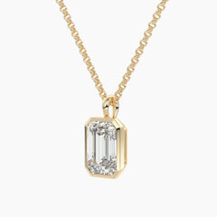 Gold chain necklace with emerald-cut moissanite pendant in solitaire setting